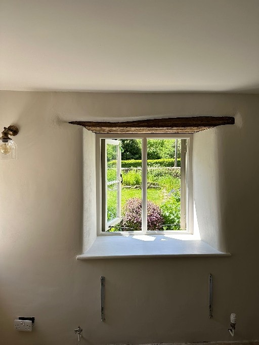Plasterer applying lime plaster by hand