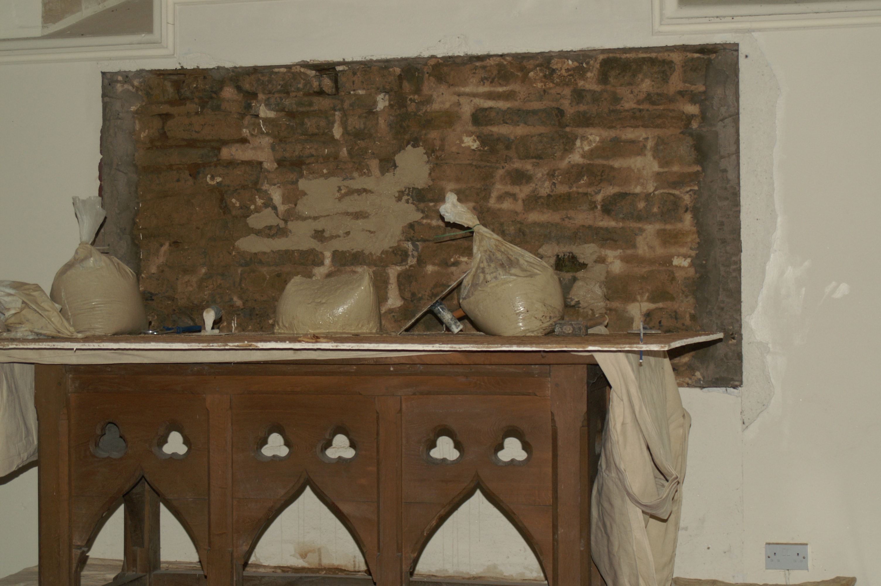 Lime plaster patch repair — texture matched to the original by hand