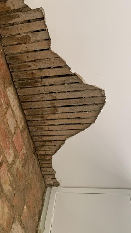 Beam junction repair — lime plaster carefully matched to the surrounding original finish