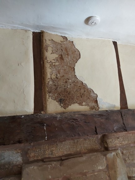 Water-damaged plaster — assessed, stabilised, and patch repaired to match the original surface